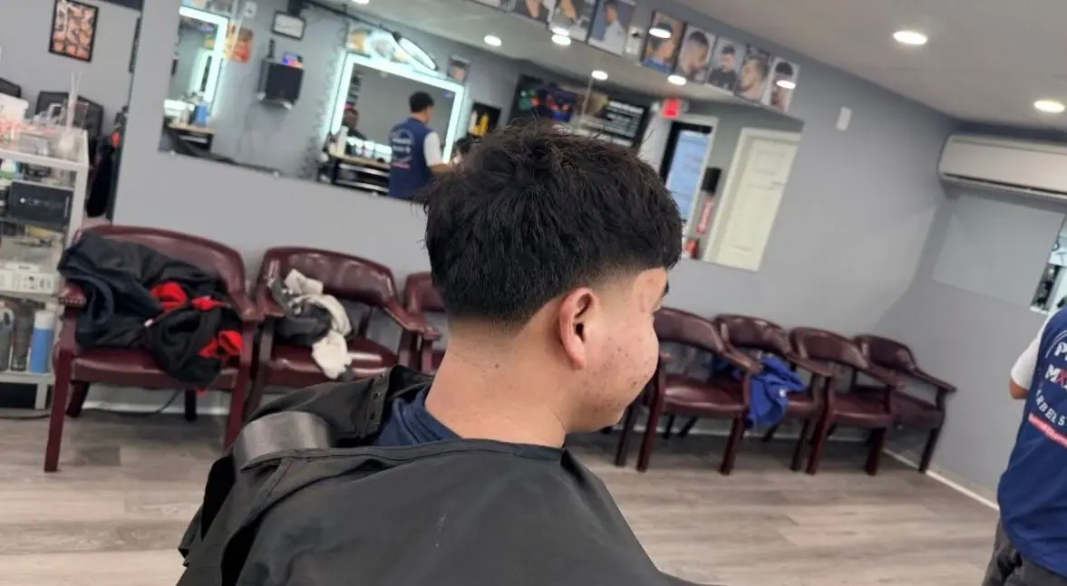 Rear view of a textured crop with a low taper fade