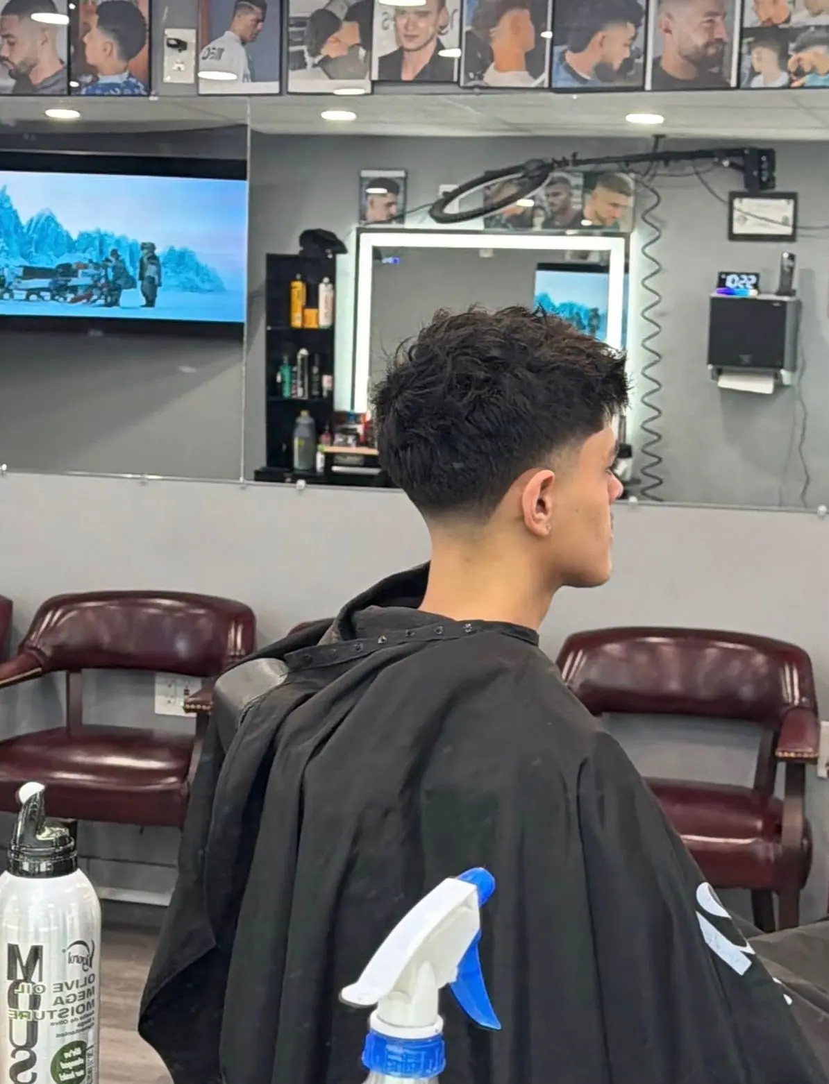 Messy textured fringe with a low taper fade, seen from behind