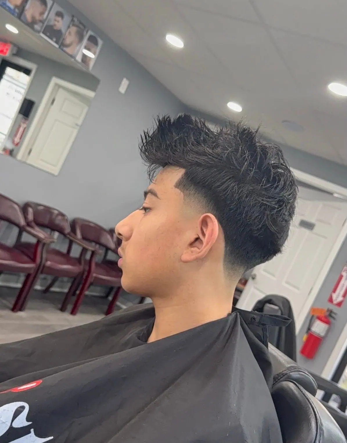 Close-up side profile of a textured top with a taper fade