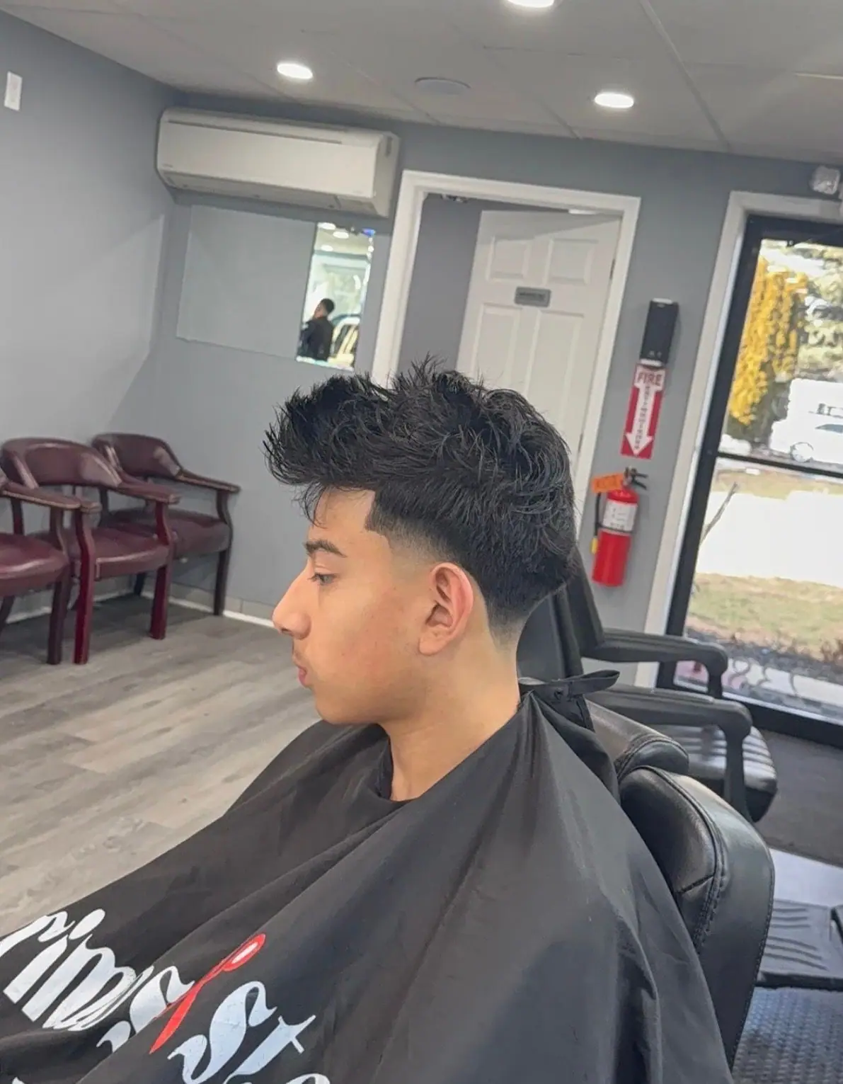 Spiky textured top with a low taper fade and sharp lineup